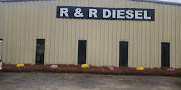 Exterior of the R&R Diesel workshop with a beige metal building